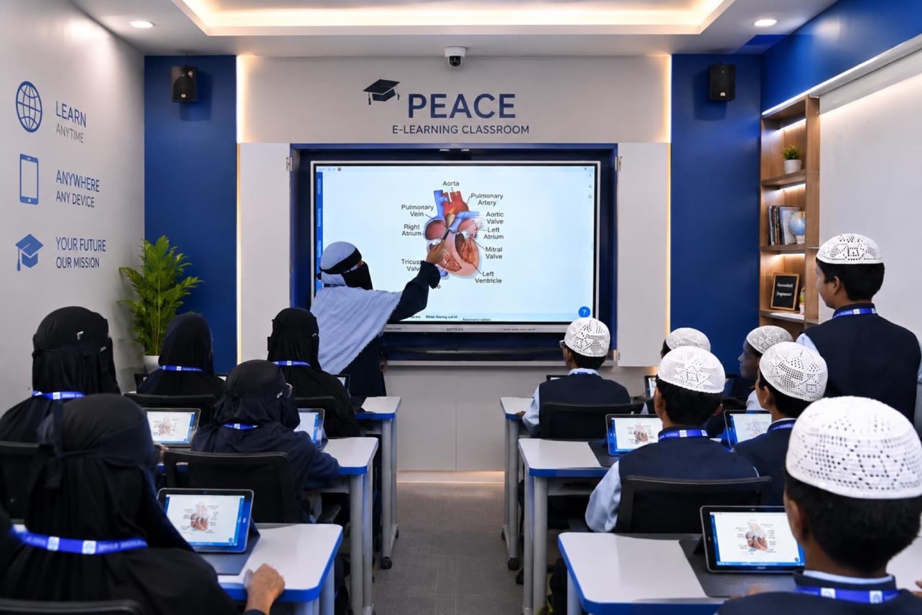 A Peace e-learning classroom with an interactive panel and students on tablets